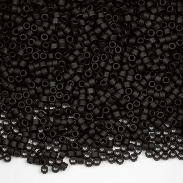 A 7.2-gram tube of Miyuki 11/0 Matte Black Delica seed beads (#DB310), featuring uniform, precision-cut glass seed beads with a smooth matte finish, ideal for bead weaving and intricate jewelry designs.