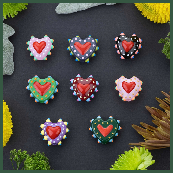 Handmade glass heart beads for festive DIY projects.