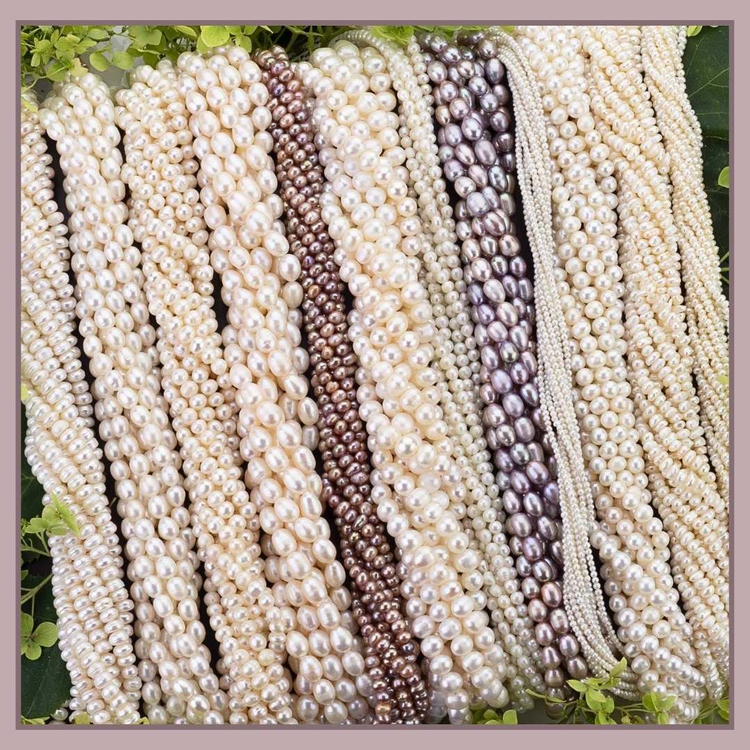 Freshwater pearls arranged on a black background.