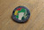 Badge has a map of Ireland, clenched fist, the Spanish Republican and Starry Plough flags and the text IRELAND REMEMBERS THE XV INTERNATIONAL BRIGADE 1936-39 