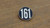 161 black enamel badge