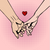 Graphic from bottle label: 
Illustration of a couple linking pinkies with a little red heart above their hands in the middle