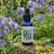 Jacob's Ladder flower essence bottle in a lush garden with Jacob's Ladder plants blooming behind it.