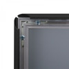 Corner of a black snap frame opened to show the snap rail and hidden mounting screws