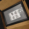 Boxed black snap frame with the included mounting screws and instructions