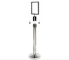 Silver sign holder fitted to the top of a queue barrier post