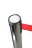 Silver retractable belt queue barrier with a red belt in use