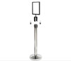 Silver sign holder fitted to the top of a queue barrier post