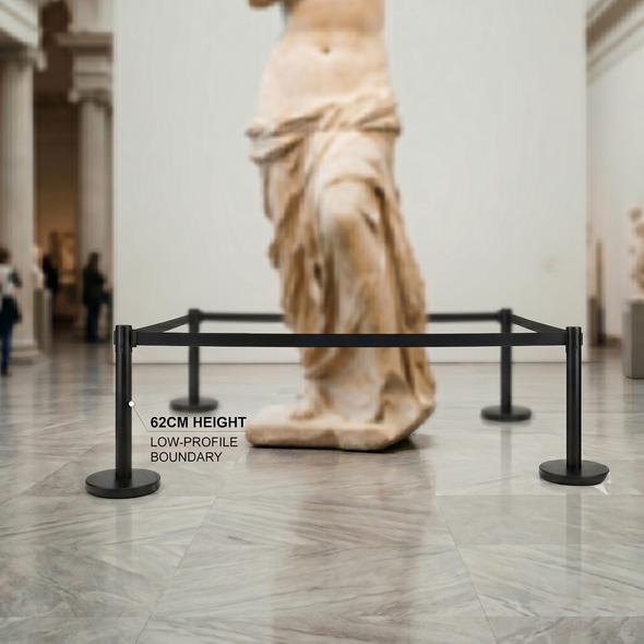 Black retractable belt queue barrier with a black belt in use