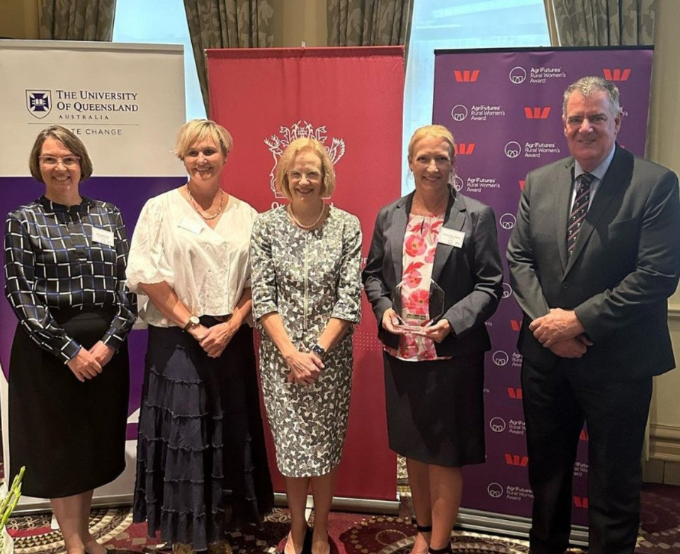 Emma Gibbons holding the 2023 AgriFutures Rural Women's Award for Queensland, standing with award presenters