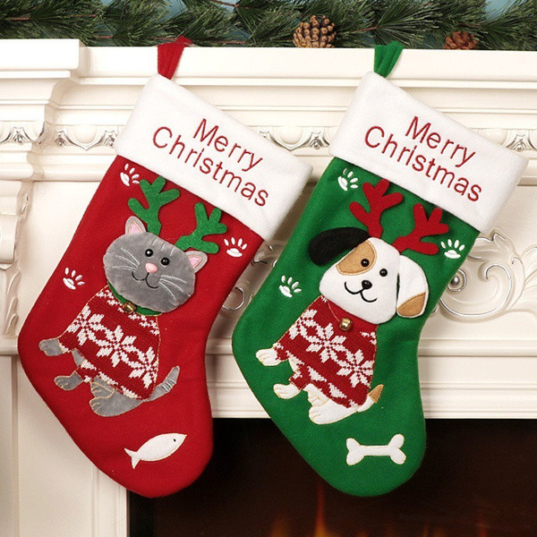 Cat and Dog Christmas Stocking in red and green, hung on a mantel, from Huds and Toke
