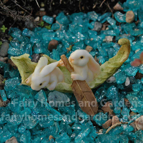 Miniature Rabbits Rowing a Leaf Boat