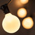 WGC-71992 - 15' Pearl White Incandescent Commercial Satin Patio String Light Set with 15 G50 Bulbs, E12 Base, Black Wire, 12" Spacing - Wintergreen Corporation