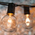 WGC-71990 - 15' Clear Incandescent Commercial Patio String Light Set with 15 G50 Bulbs, E17 Base, Black Wire, 12" Spacing - Wintergreen Corporation