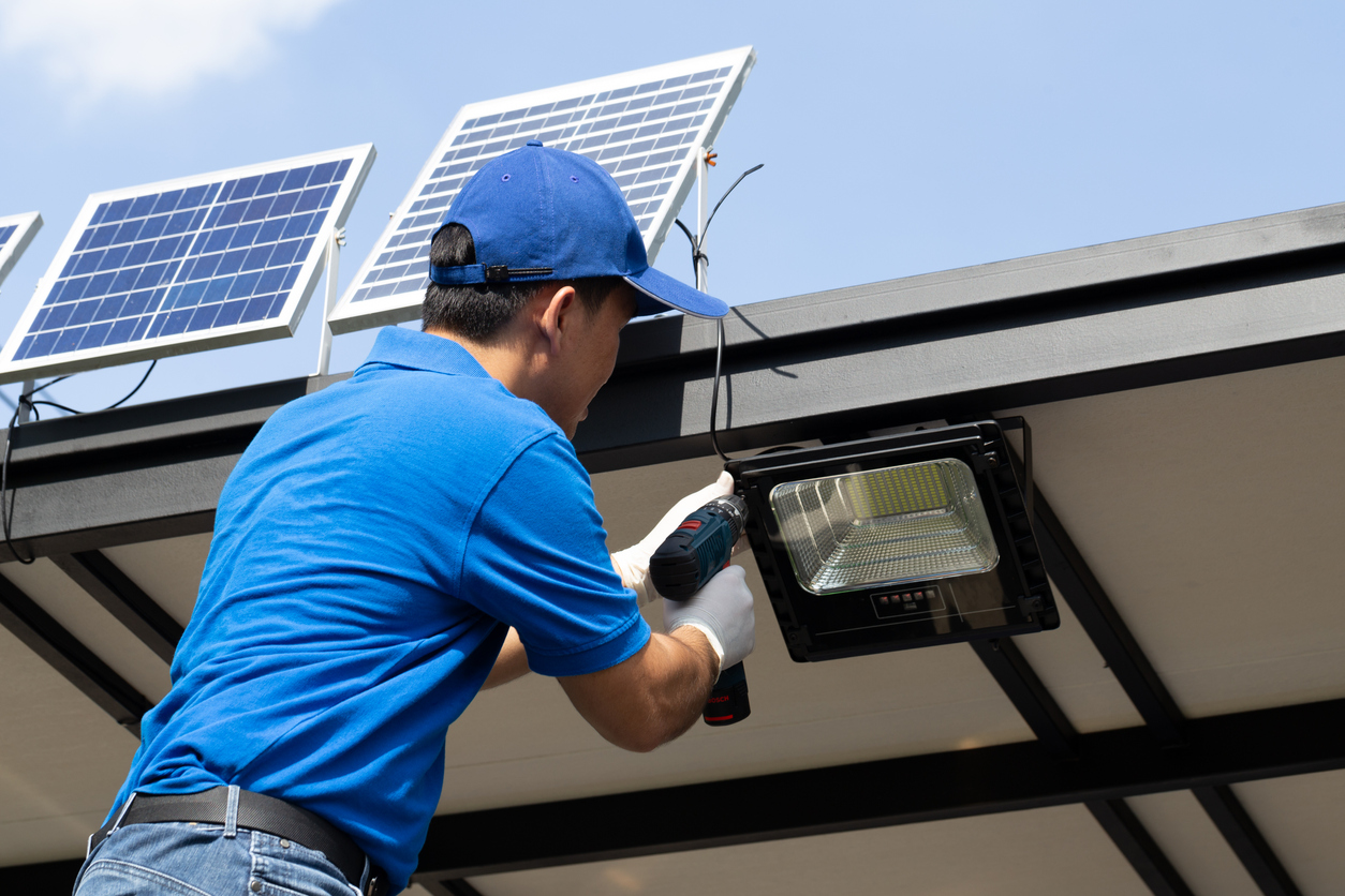 man-installing-solar-photovoltaic-panels-for-led-lamps-on-the-roof-of-the-house.jpg