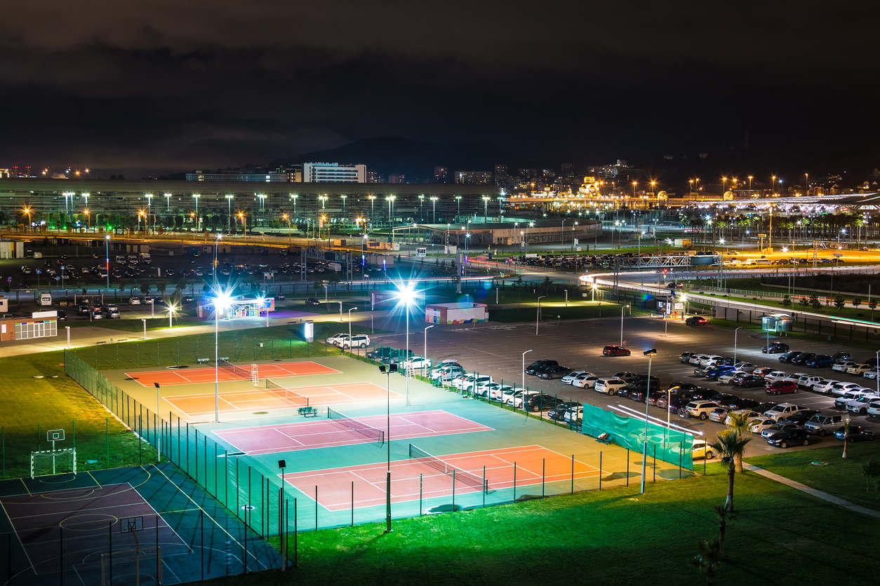 tennis-court-and-parking-lot-lit-at-night.jpg