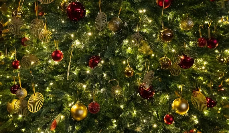 Christmas tree with gold and red ornaments and warm lights
