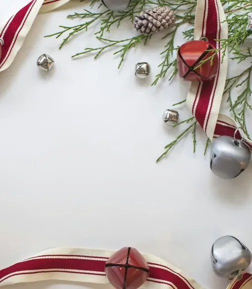 Striped Christmas ribbon with jingle bells and greenery
