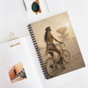 Still Waiting for You desert rider spiral notebook featuring cinematic bicycle artwork, warm dusty tones, and a distant sculptural desert landscape.