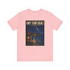 Pink Dry Tortugas National Park Florida shark T-shirt featuring vintage-inspired MOMENT No. 003 artwork with a nighttime fisherman, shark, Fort Jefferson and starry sky.