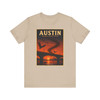 Tan Austin Texas Congress Avenue Bridge bat T-shirt featuring vintage-inspired MOMENT No. 007 artwork with bats emerging beneath the bridge at sunset.