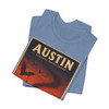 Steel Blue Austin Texas Congress Avenue Bridge bat T-shirt featuring vintage-inspired MOMENT No. 007 artwork with bats emerging beneath the bridge at sunset.
