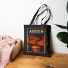 Black cotton canvas Austin Texas tote bag featuring MOMENT No. 007 Congress Avenue Bridge bat artwork.