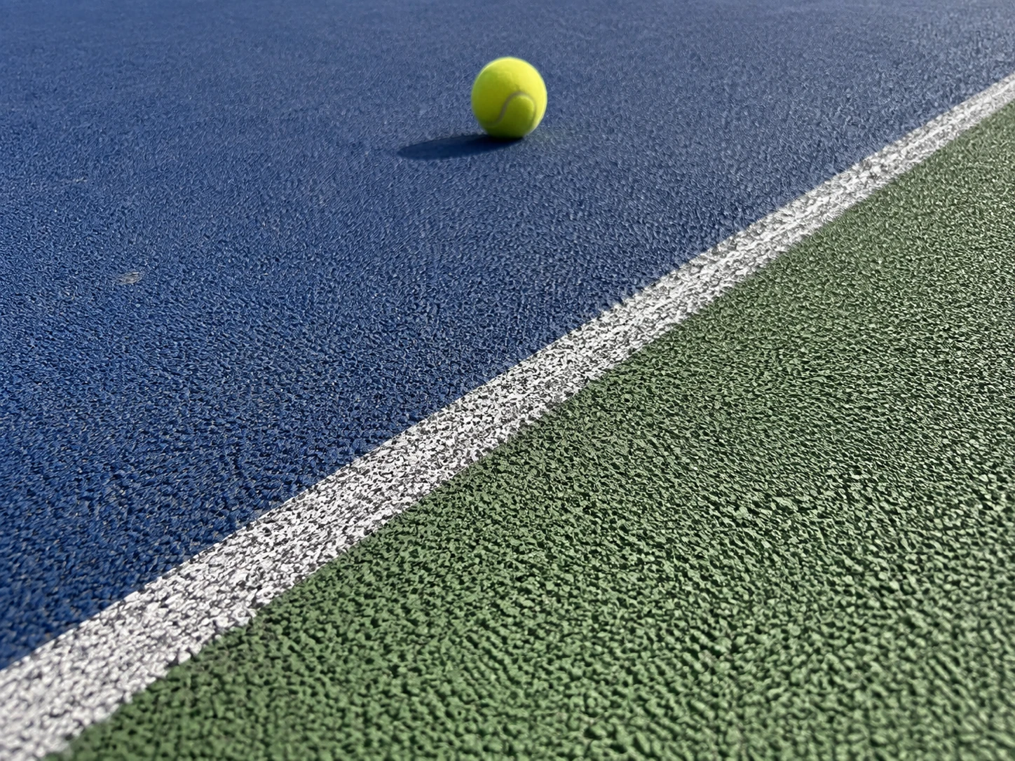 Close-up of a textured acrylic sport court surface designed for enhanced traction