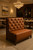 Luxury tufted leather banquette with high back, wood frame, and customizable upholstery — ideal for hospitality or dining settings.