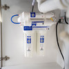 Close-up of a Cirrus 5-stage Reverse Osmosis system underneath a kitchen sink