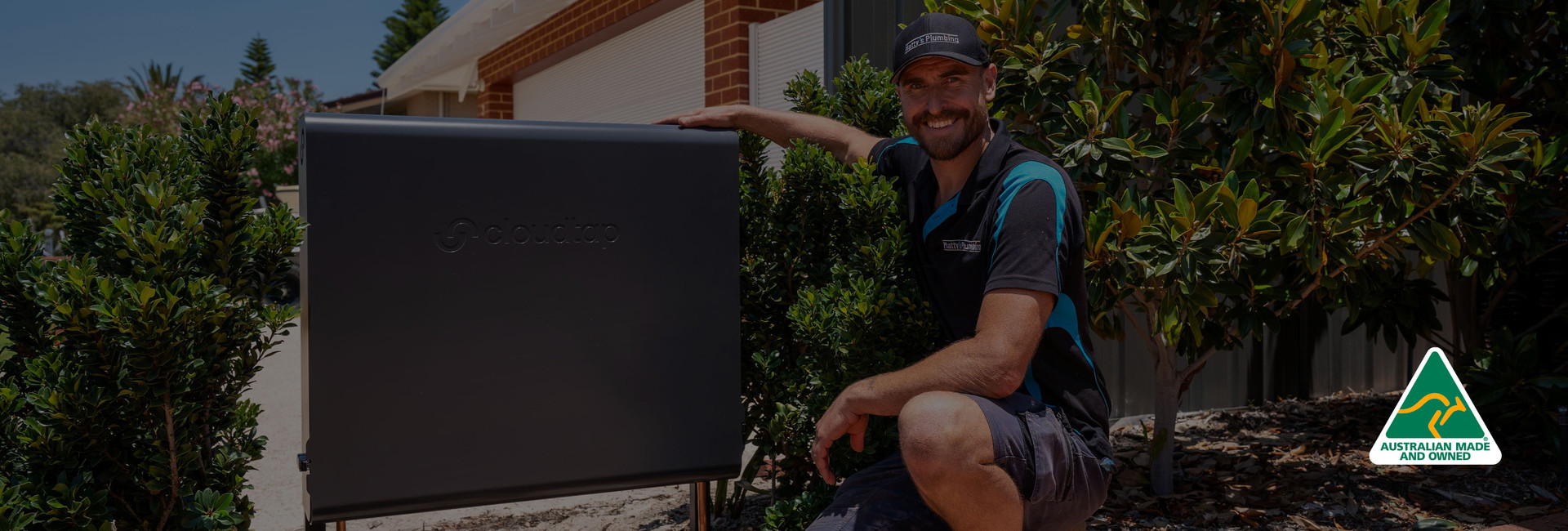 Installer posing next to a Cloudtap Design Series unit