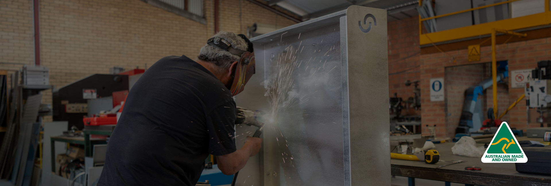 Welder working on a Cloudtap Design Series unit metal frame