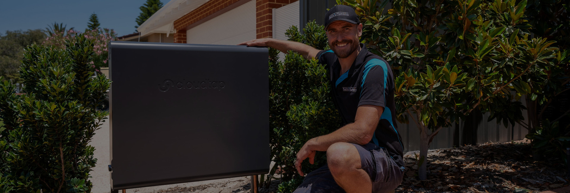 Installer posing next to a Cloudtap Design Series unit