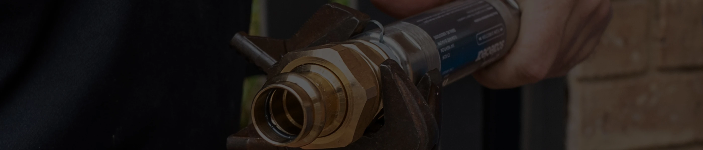 Close-up of a plumber using a wrench on a scaleclear high-flow unit