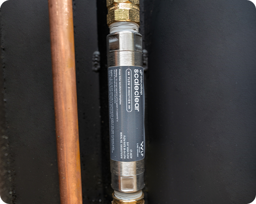 Close-up of a Scaleclear High-Flow unit attached to a copper pipe