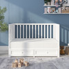 ErgoBean Basics Dual-Stage Breathable Firm Crib Mattress in a white crib in a nursery.