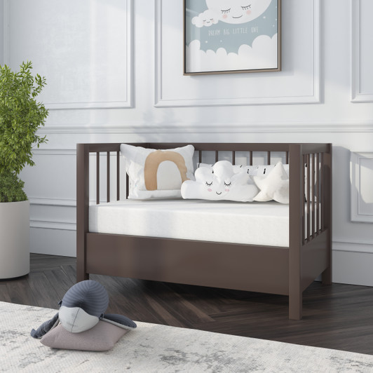 Nursery with a brown wood mini crib and ergoBean Basics Mini5 Dual -Stage Breathable Mini Crib Mattress.