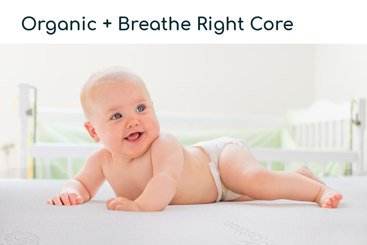 Happy Baby laying down on an organic crib mattress.