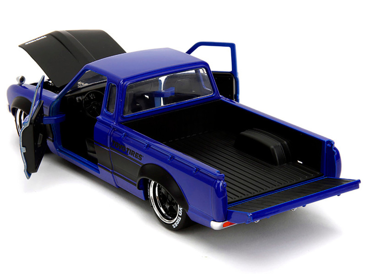 1972 Datsun 620 Pickup Truck #72 Blue Metallic with Black Stripes and Hood "Toyo Tires" with Extra Wheels "Just Trucks" Series 1/24 Diecast Model Car by Jada