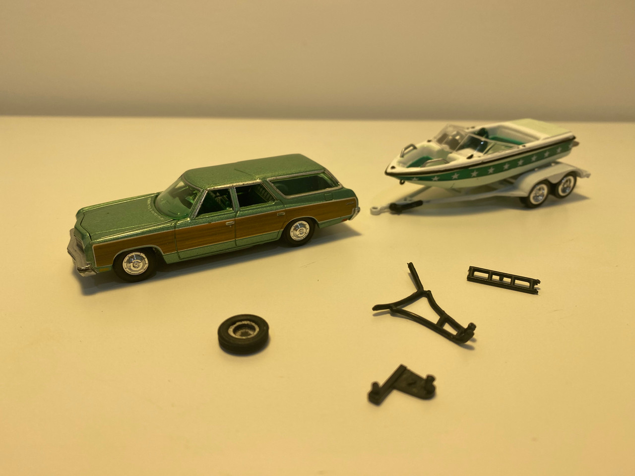 DAMAGED AS-IS 1/64 Johnny Lightning 1973 Chevrolet Caprice Wagon Light Green Metallic with Woodgrain Sides with Mastercraft Boat and Trailer Diecast Car Model