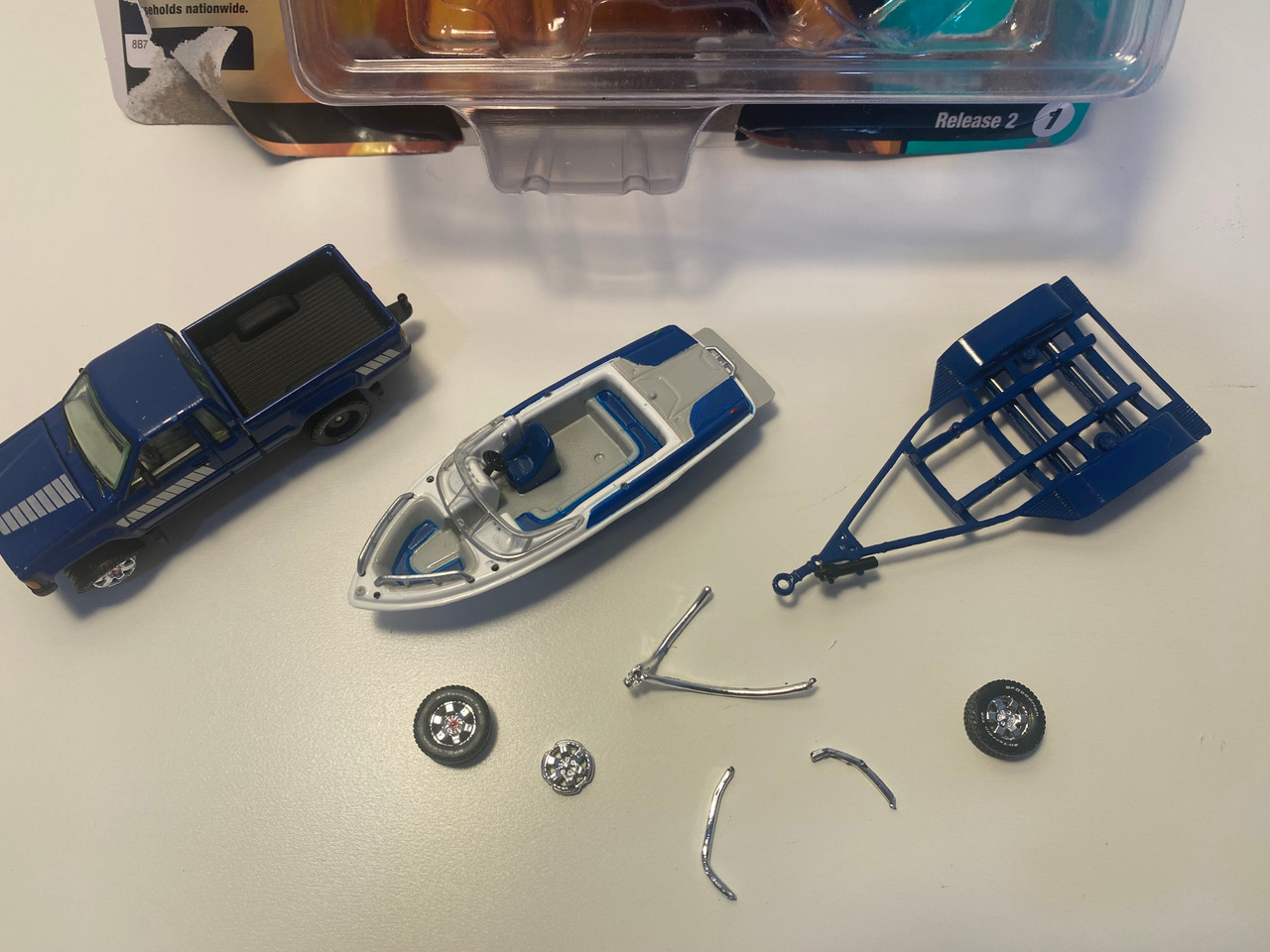 DAMAGED OPEN BOX AS-IS 1/64 Johnny Lightning 1985 Toyota SR5 Pickup with Malibu Speed Boat Trailer (Blue) Diecast Models