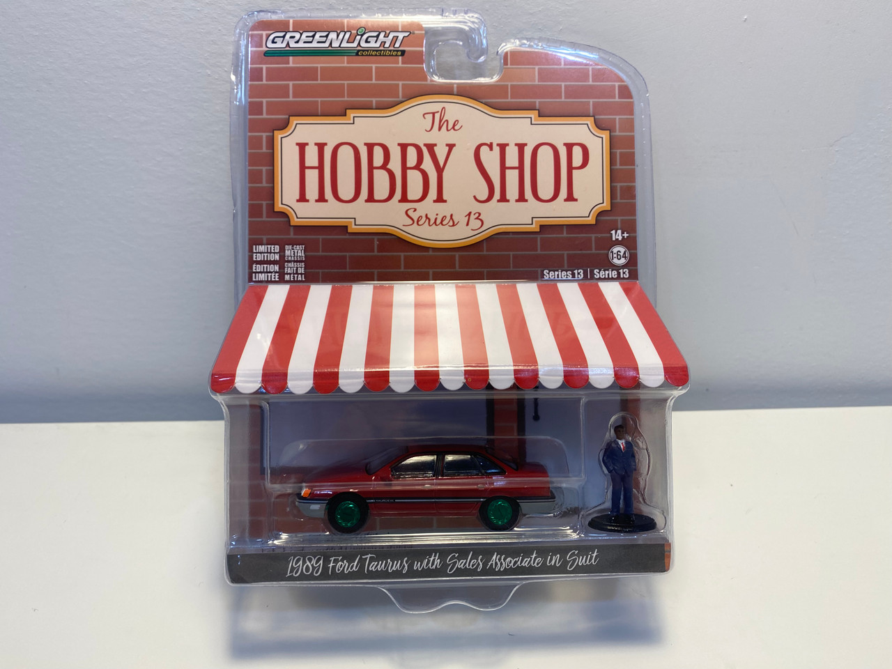 CHASE CAR 1/64 Greenlight 1989 Ford Taurus Red with Black Stripes and Sales Associate in Suit Figure "The Hobby Shop" Series 13 Diecast Car Model