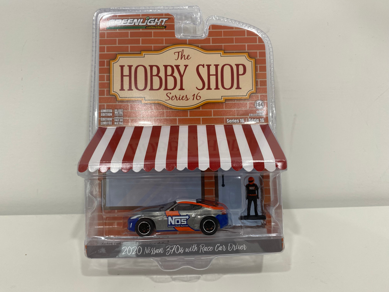 CHASE CAR 1/64 Greenlight 2020 Nissan 370z "NOS Nitrous Oxide Systems" (Chrome Silver with Graphics & Race Car Driver) "The Hobby Shop" Series 16 Diecast Car Model