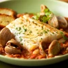 A savory black cod fillet portion with clams.