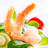 Two large crisp shrimp nestled in a fresh salad.