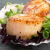 Jumbo caramelized scallops in bed of lettuce.
