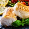 Flaky Alaska cod portions with roasted asparagus & tomatoes.