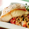 A delicious black cod fillet portion on a bed of rice.