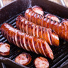 Sliced Alaska Reindeer Sausage in grilling pan.