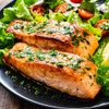 Two delicious roasted Copper River king salmon fillets with festive salad.